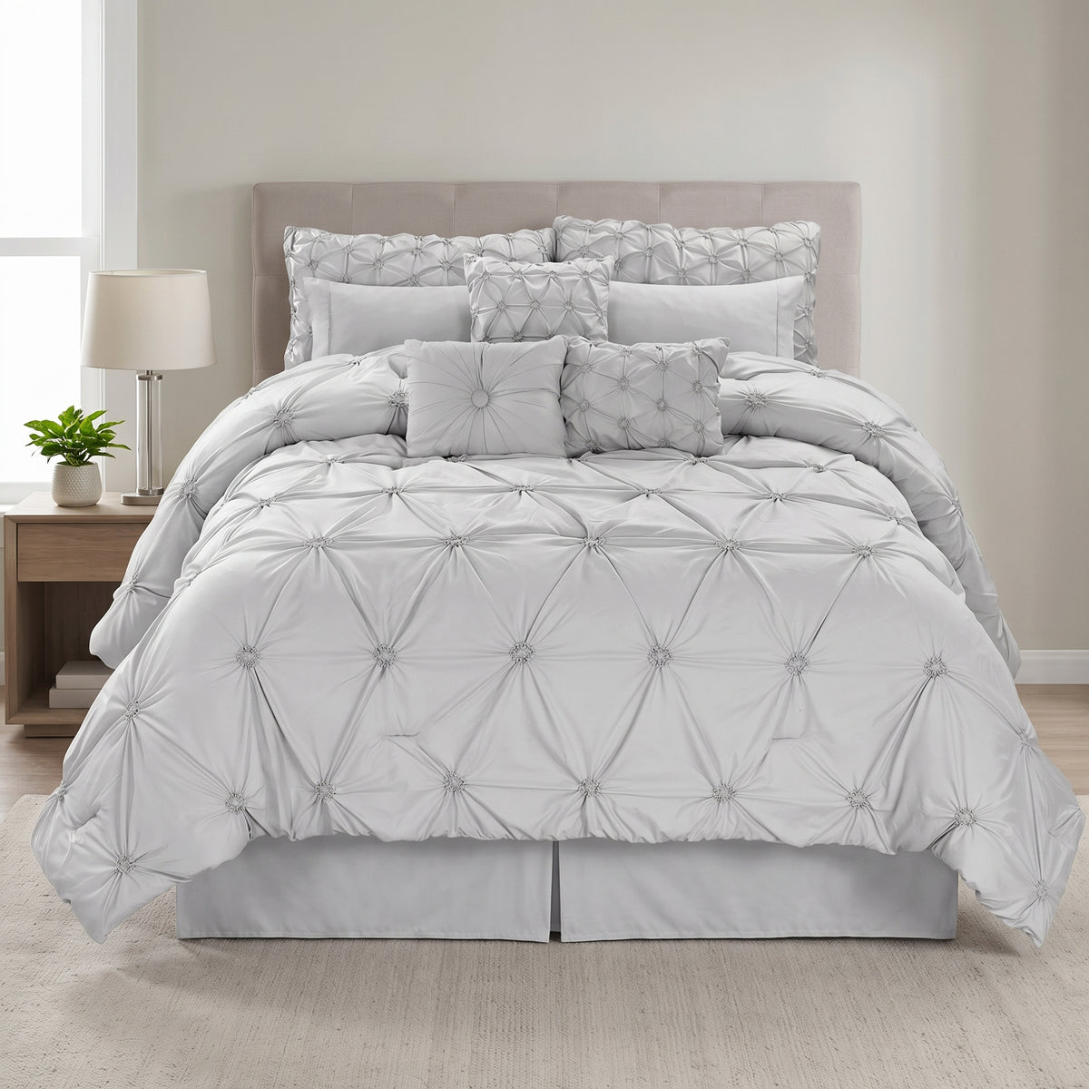 Chateau 7-piece queen pinch pleat comforter set in grey in a bright bedroom, front view