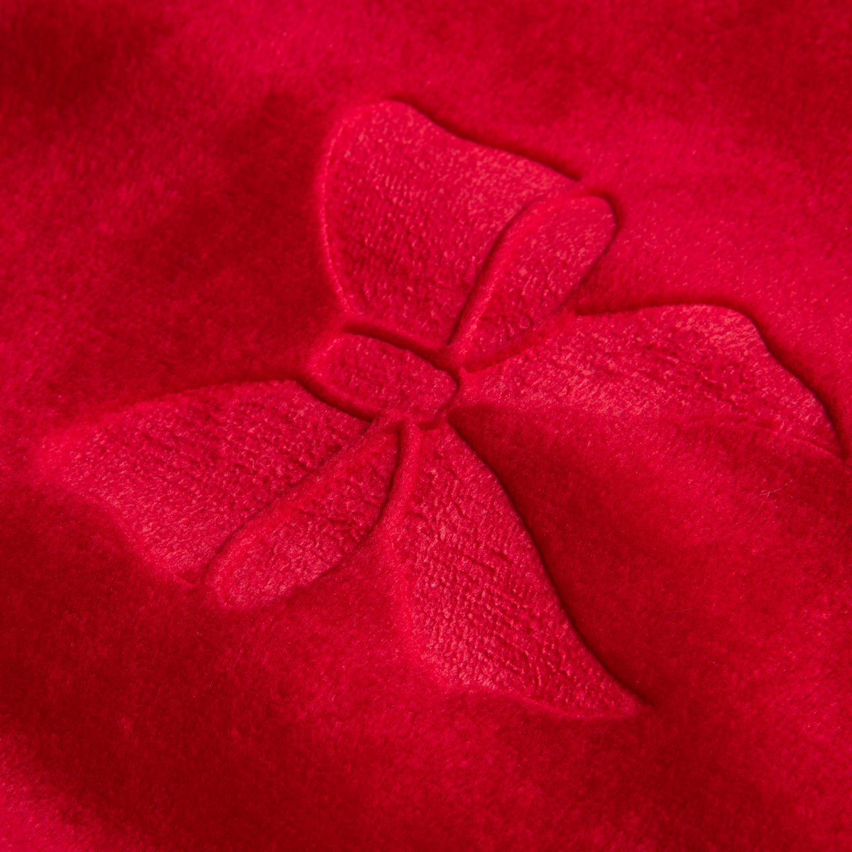 Red plush Christmas throw blanket with embossed bows