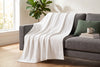 Couverture jacquard, blanc cassé, dans un décor