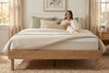 King platform bed frame in natural oak-look finish, bedroom styling view 4