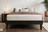 King platform bed frame in black wood-grain finish, bedroom styling view 2