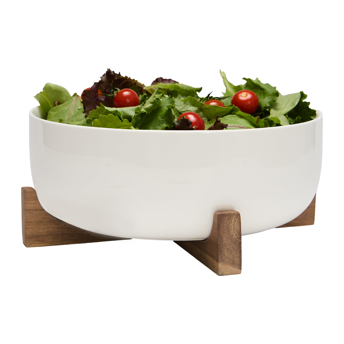 White porcelain serving bowl with salad on acacia stand
